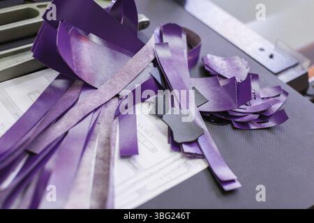 Close-up of purple parts of handbags lying on the paper Stock Photo