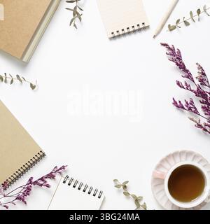 Notebooks and black tea, pencil, dry flowers on white background. flat lay, top view, copy space. Work and study place Stock Photo