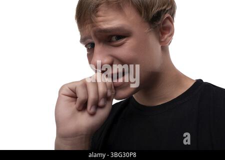 Portrait of a smart blond teenager guy looking thoughtfully against a background with copy space Stock Photo