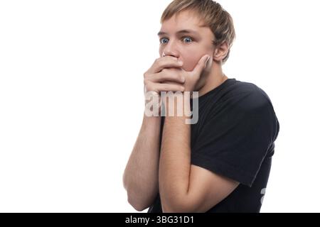 Surprised blond teenager young man close-up on a background with copy space Stock Photo