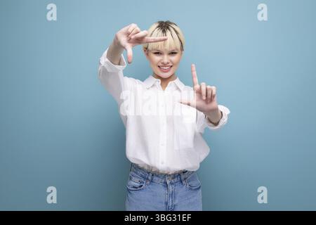 Young pretty caucasian blond career woman in white blouse is friendly looks at the camera Stock Photo