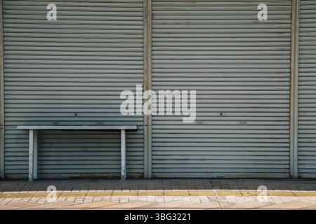 Metallic roller shutter door with desk Stock Photo