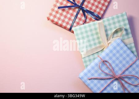 Check pattern colorful gift boxes on pink background Stock Photo