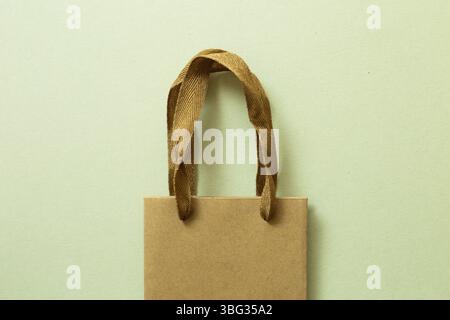 Brown kraft paper shopping Bag on green background. top view Stock Photo