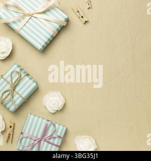 Green gift boxes on beige fabric background. flat lay, top view, copy space Stock Photo
