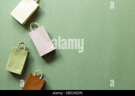 Paper shopping bags on green background. top view, copy space Stock Photo