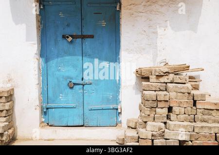 Old house exterior, Blue door and stacked bricks in Madurai, India, Asia Stock Photo