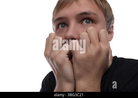 Afraid young man with blond hair wearing a black T-shirt Stock Photo