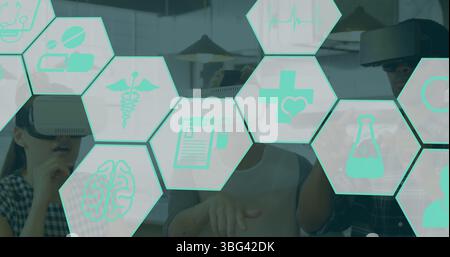 Image of medical icons over diverse people using vr headsets Stock Photo
