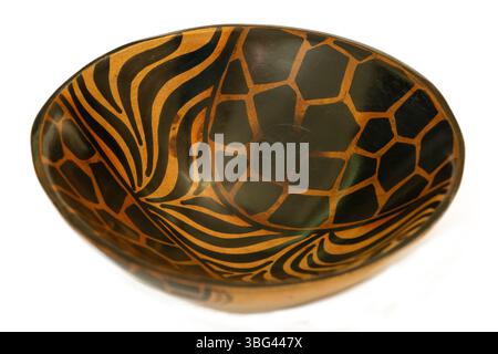 A traditional African hand-carved wooden bowl isolated against a white background Stock Photo
