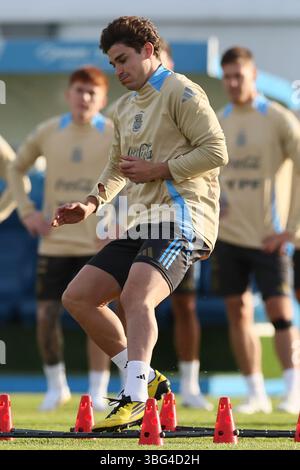 Argentina's national team forward Julian Alvarez (R) makes excersices