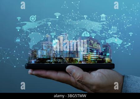 Hand holding smartphone with smart city hologram and digital connection icons. Concept of internet of things, communication, big data, urban technolog Stock Photo