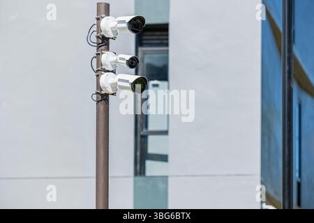 CCTV multi angle cameras security in office building area. Surveillance Video Camera on Pole at building background. Stock Photo