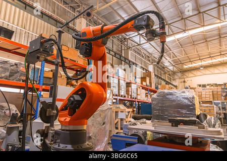 Robotic Smart Welding Machine. Welder arm machine, Robotic Welding or Robotic Arm Welding at Industrial Factory. Stock Photo