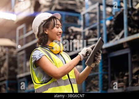 Happy Asian women engineer staff worker enjoy working in factory heavy industry. Stock Photo