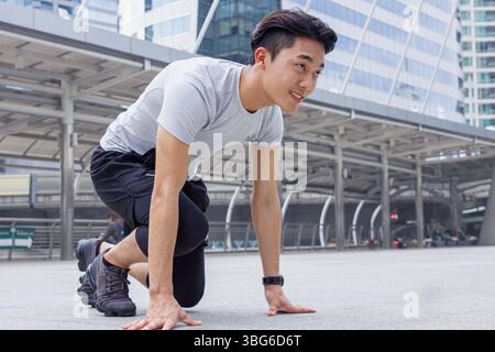 Sport Healthy Asian Chinese young man prepare ready for go running at city outdoor office building background Stock Photo