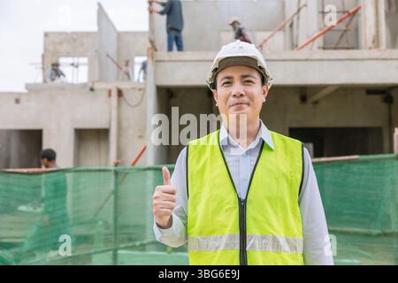 Portrait senior construction engineer builder thumbs up, Happy smiling architect adult asian man, Confirm approved project Stock Photo