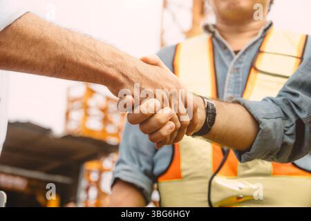 Workers team hand shaking deal with contractor happy at construction site. Engineer project business contact connection people concept. Stock Photo