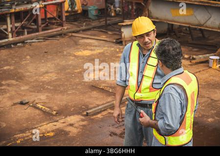 Construction engineer team working together join teamwork talking together at construction site Stock Photo
