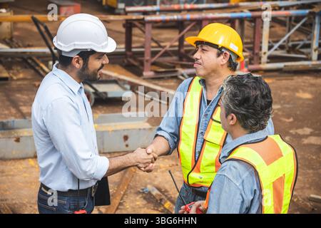 Workers team hand shaking deal with contractor happy at construction site. Engineer project business contact connection people concept. Stock Photo