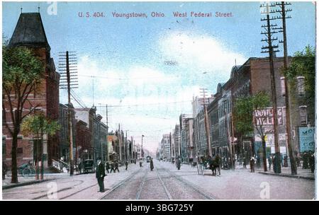 1907 colorized view of West Federal Street in Youngstown, Ohio, showing pedestrians, trolley tracks, and horse-drawn carriages. Stock Photo