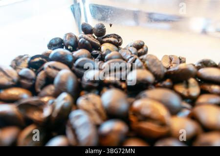 A detailed close-up view of freshly roasted coffee beans, showcasing their rich textures and deep brown colors, perfect for coffee lovers and enthusia Stock Photo