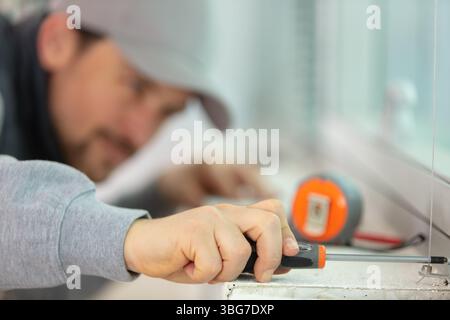close up of construction worker preparing to fit new windows Stock Photo