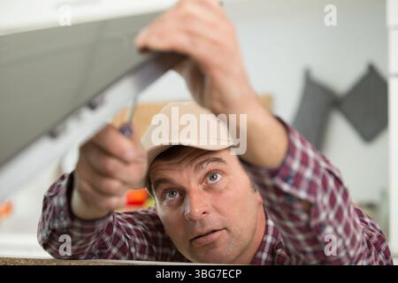 builder sets fittings on the window Stock Photo