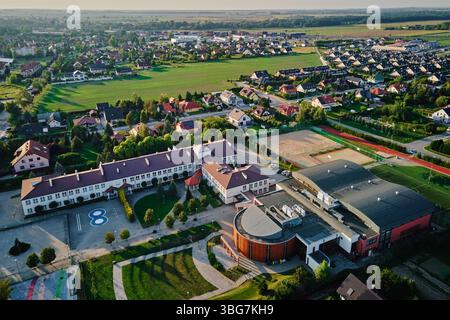 School Complex with Sports Fields and Urban Landscape - Aerial View ...
