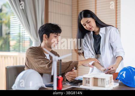 ESG-focused Collaboration in Sustainable Architecture. Two professionals discussing eco-friendly design. Stock Photo
