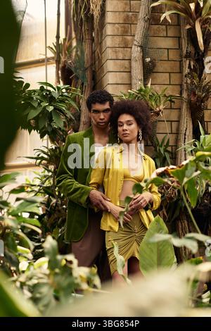Nude young couple between plants in the forest Stock Photo - Alamy