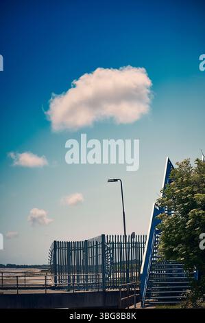 Small white cloud floating over  abandoned ferry terminal in Fleetwood,UK Stock Photo