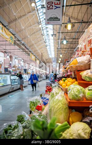 WASHINGTON DC — Eastern Market stands as a vibrant historic public market in the Capitol Hill neighborhood of Washington DC. Established by presidential proclamation from Thomas Jefferson in 1805 and housed in its current brick building since 1873, the market was designed by noted German-American architect Adolf Cluss with additions by Snowden Ashford in 1907-8. Now listed on the National Register of Historic Places, this enduring commercial hub continues to serve as a lively community gathering place for local vendors, fresh produce, and artisanal goods. Stock Photo