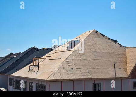 Plywood sheathing layer during roof building construction on new residential home Stock Photo