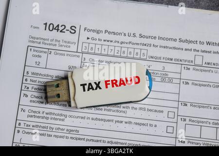 USB drive with text tax fraud and tax form. Business and finance concept Stock Photo