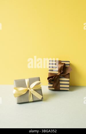 Gift boxes on gray table. yellow wall background Stock Photo