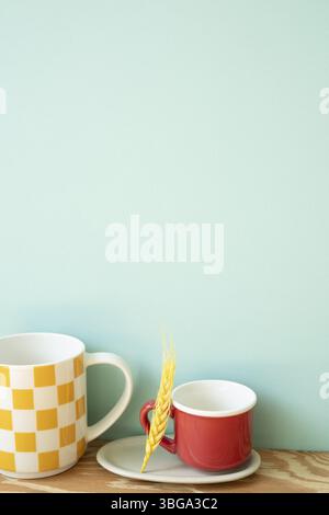 Empty mug cups on wooden shelf. mint wall background Stock Photo