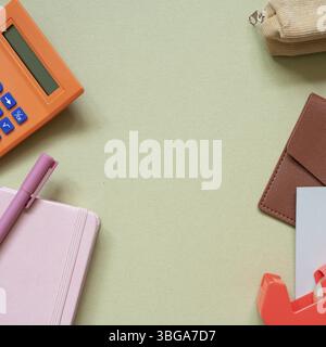 Various office and school supply. calculator, pen, notebook, pencil case, card wallet, memo pad, tape dispenser on khaki desk background. top view Stock Photo