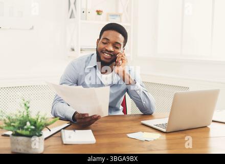 Young black businessman talking on mobile phone Stock Photo