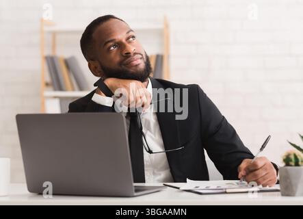 Dreamy entrepreneur thinking about his company future Stock Photo