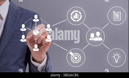 Unrecognizable entrepreneur touching white icons on interactive screen Stock Photo