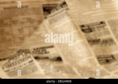 Blurred old newspaper in brown tones as a background for retro design or vintage layouts Stock Photo