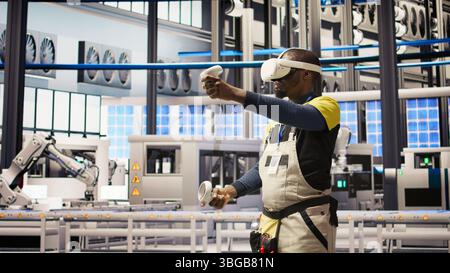 Smart factory specialist using virtual reality simulation to predict equipment failures. Industry 4.0 plant engineer using VR headset to follow maintenance procedures and repair damages, camera A Stock Photo