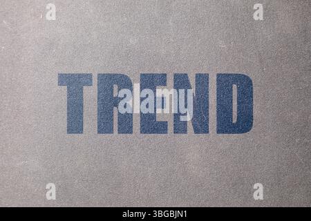 Trend. Blue word on grey textured background Stock Photo