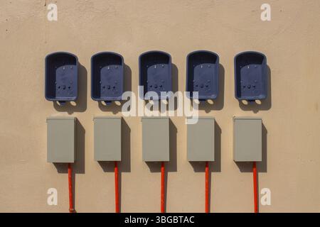 plastic boxes for electric meters on the wall Stock Photo