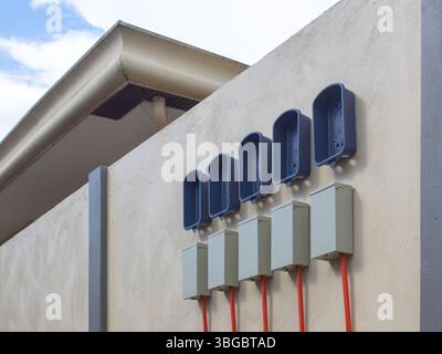 plastic boxes for electric meters on the wall Stock Photo