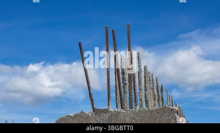 metal fittings in a monolithic concrete block, against a blue sky, beautiful background Stock Photo