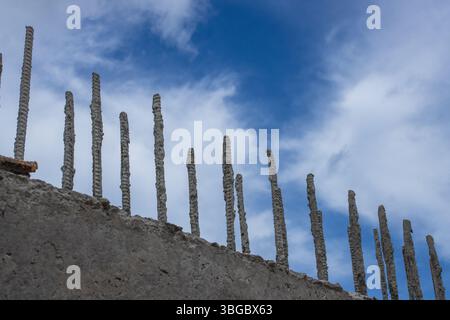 metal fittings in a monolithic concrete block, against a blue sky, beautiful background Stock Photo
