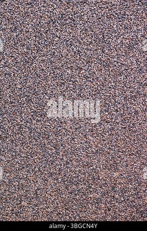 This is a closeup view of a beautifully designed carpet that features a lot of small stones scattered across its surface Stock Photo