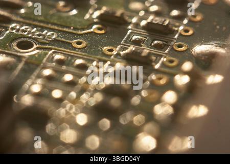 Close-up of an electronic circuit board highlighting intricate connections and technological components Stock Photo